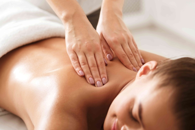 Full body massage session in a serene spa room.